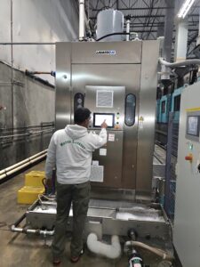 A Metro Laundry Service operator makes adjustments to the 15 compartment LAVATEC tunnel wash system the company has run since 2012.